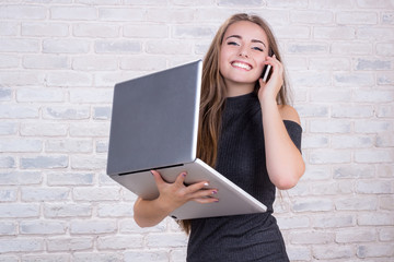 Female long-haired office manager or administrator with notebook, telephone