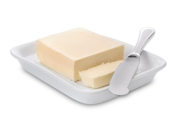 Plate with tasty fresh butter and knife on white background