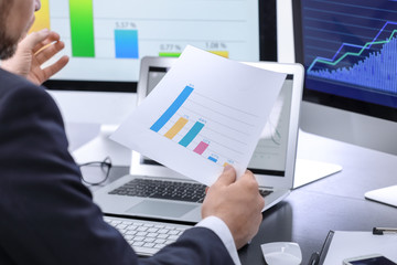 Male broker working in office. Finance trading concept