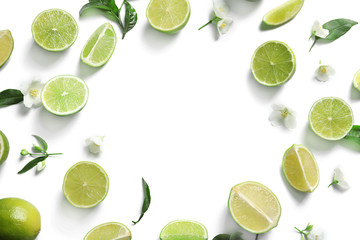 Frame of fresh ripe limes on white background, top view