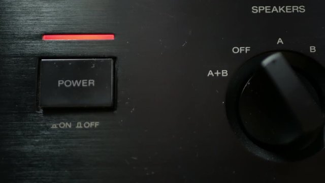 Turn on home audio amplifier receiver close-up