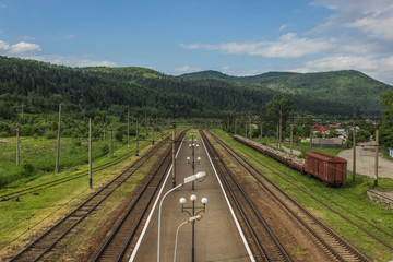 Fototapeta na wymiar railroad station near mountain landscape