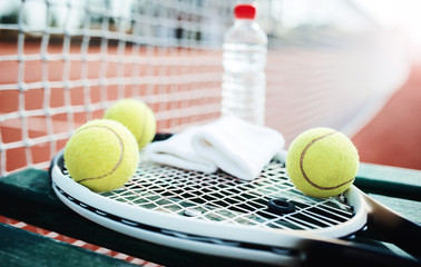 Tennis ball with racket on the tennis court. Sport, recreation concept