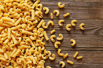 Yellow italian pasta on a wood rustic background