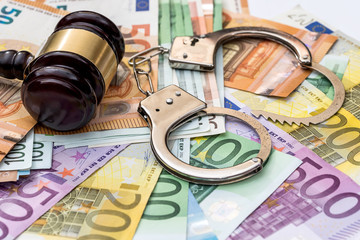 Justice, bribery and punishment. Euro with handcuffs and gavel