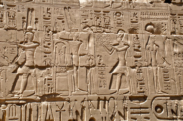 Hieroglyphs carved on the wall of the ancient temple of Karnak. Luxor, Egypt