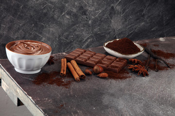 Chocolate bars on table with chocolate powder.