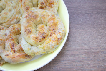 Baked snack with stuffing with golden crust. Traditional moldavian food called platzinda