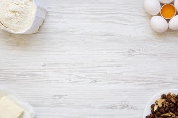 Ingredients for making cookies on white wooden background. Top view. From above, flat lay. Copy space.