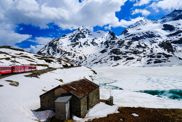 The Bernina express among snow, clouds and mountains