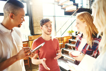 Creative young business team gathered together to discuss ideas. Team leader explaining his point of view
