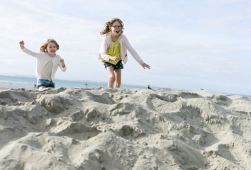 Two sisters on the beach acting crazy