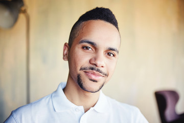 Portrait of handsome mixed race young man looking at camera feeling confident