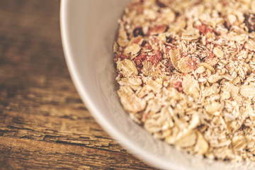 Cereal in a white bowl on wood