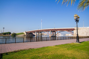 Sharjah corniche park with beautiful greenery, union flag and cornice bridge