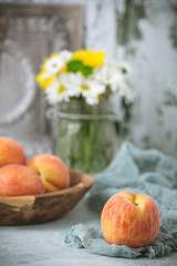 Fresh Peaches in a Wood Bowl on Soft Green Background