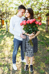 young loving couple in love, girl holding flowers, happy and enjoy the beautiful nature, advertising, and utsava text