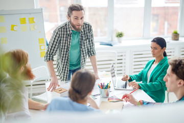 Businessman communicating with his team at business presentation