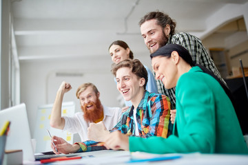 Fototapeta premium Happy group of designers leading a presentation on laptop