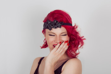 Naklejka premium young woman laughing hard covering mouth with hand