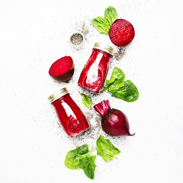 Beetroot smoothies with chia seeds, glass bottles, gray background, top view