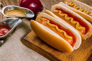 three classic hot dogs with ketchup and mustard
