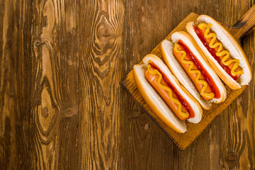 three classic hot dogs with ketchup and mustard