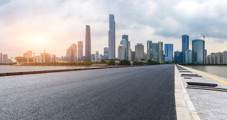 Fototapeta na wymiar asphalt road and modern city skyline in Guangzhou at sunset,China
