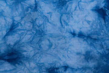 Pattern of blue tie batik dye on cotton cloth, Dyed indigo fabric background and textured