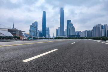 asphalt road and modern city skyline in Guangzhou at dusk,China