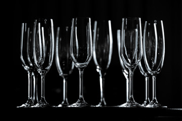 Champagne glasses on table, low key.