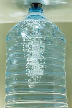 pouring water in the bottle with water dispenser