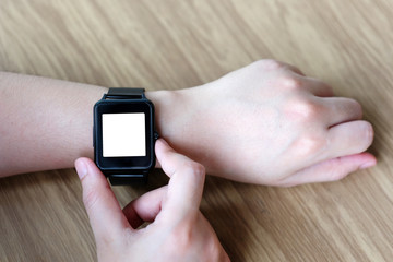 Man hand touching smartwatch with blank on screen, mock up, template, technology lifestyle concept
