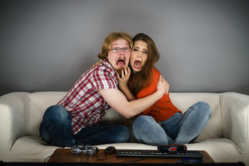 Fototapeta premium Funny couple watching horror movie