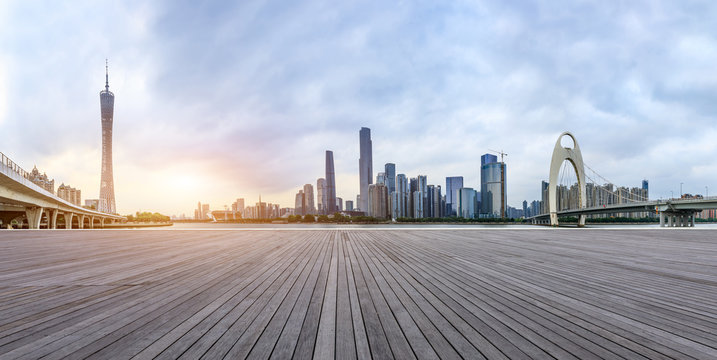 wood square floors and modern city skyline in Guangzhou at sunset,China