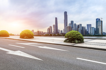 asphalt road and modern city skyline in Guangzhou at sunset,China