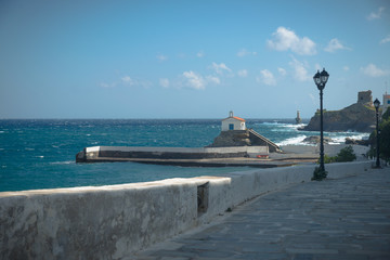 Mediterranean church and lighthouse on the coastline of the Greek island of Andros