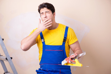 Young contractor employee applying plaster on wall