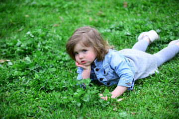 Fototapeta premium Girl lie on summer or spring meadow
