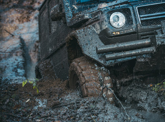 4x4 or 4WD car with wheels in mud