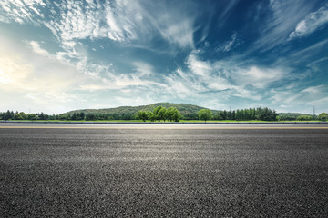 Asphalt road and mountain with sky clouds landscape at sunset - obrazy, fototapety, plakaty