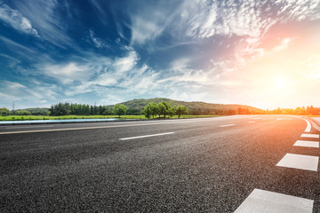Fototapeta premium Asphalt road and mountain with sky clouds landscape at sunset