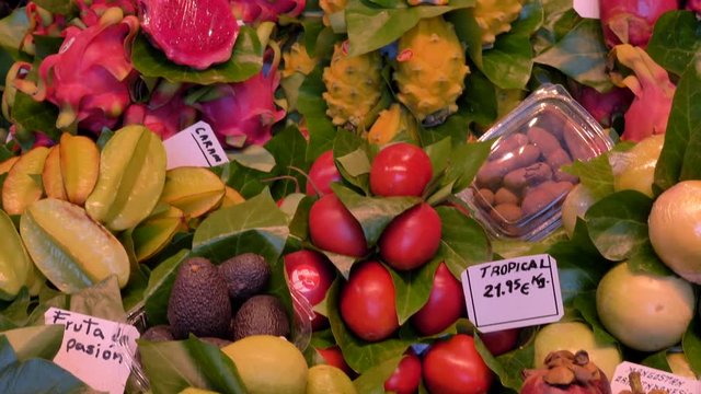 La Boqueria market - The famous fruit stand with a stunning display of products. La Boqueria is a large public market and one of the city's foremost tourist landmarks