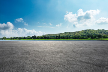 Asphalt square road and hills with sky clouds landscape - obrazy, fototapety, plakaty