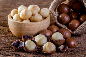 Macadamia nut on wooden table. - obrazy, fototapety, plakaty