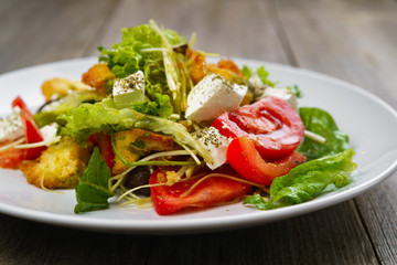Appetizing vegetable salad with letuce and croutons. Mediterranean cuisine, banquet, restaurant menu food photo, dining concept
