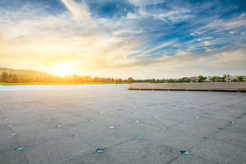 Empty square floor and apartment building with cloud landscape in the city suburbs