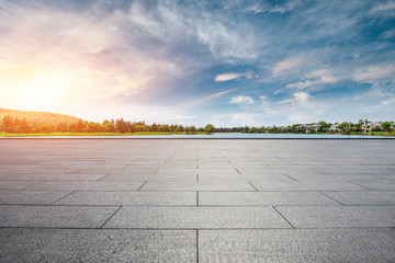 Empty square floor and apartment building with cloud landscape in the city suburbs