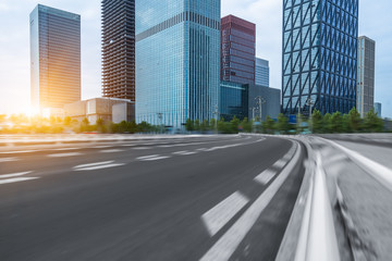 Fototapeta premium city empty traffic road with cityscape in background.