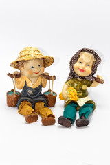 Pottery figurine of boy in straw hat with pails of water